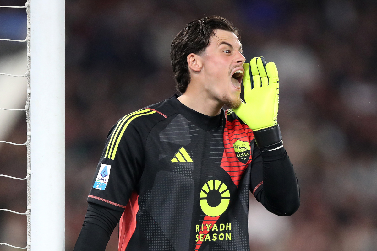Roma goalkeeper Mile Svilar between the Belgian and Serbian national-team flags