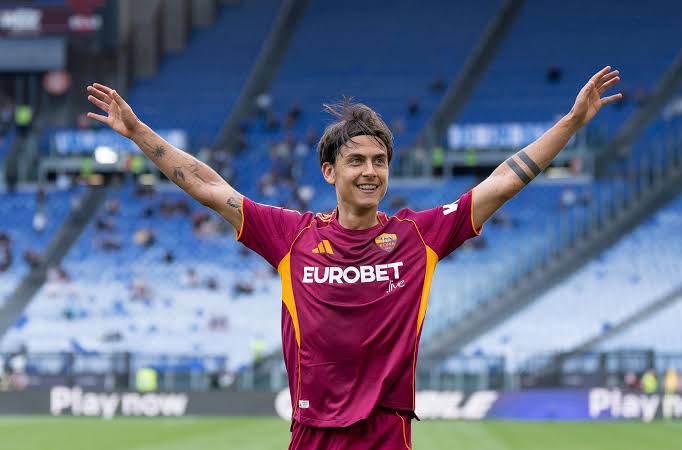 Paulo Dybala wearing Roma’s home shirt